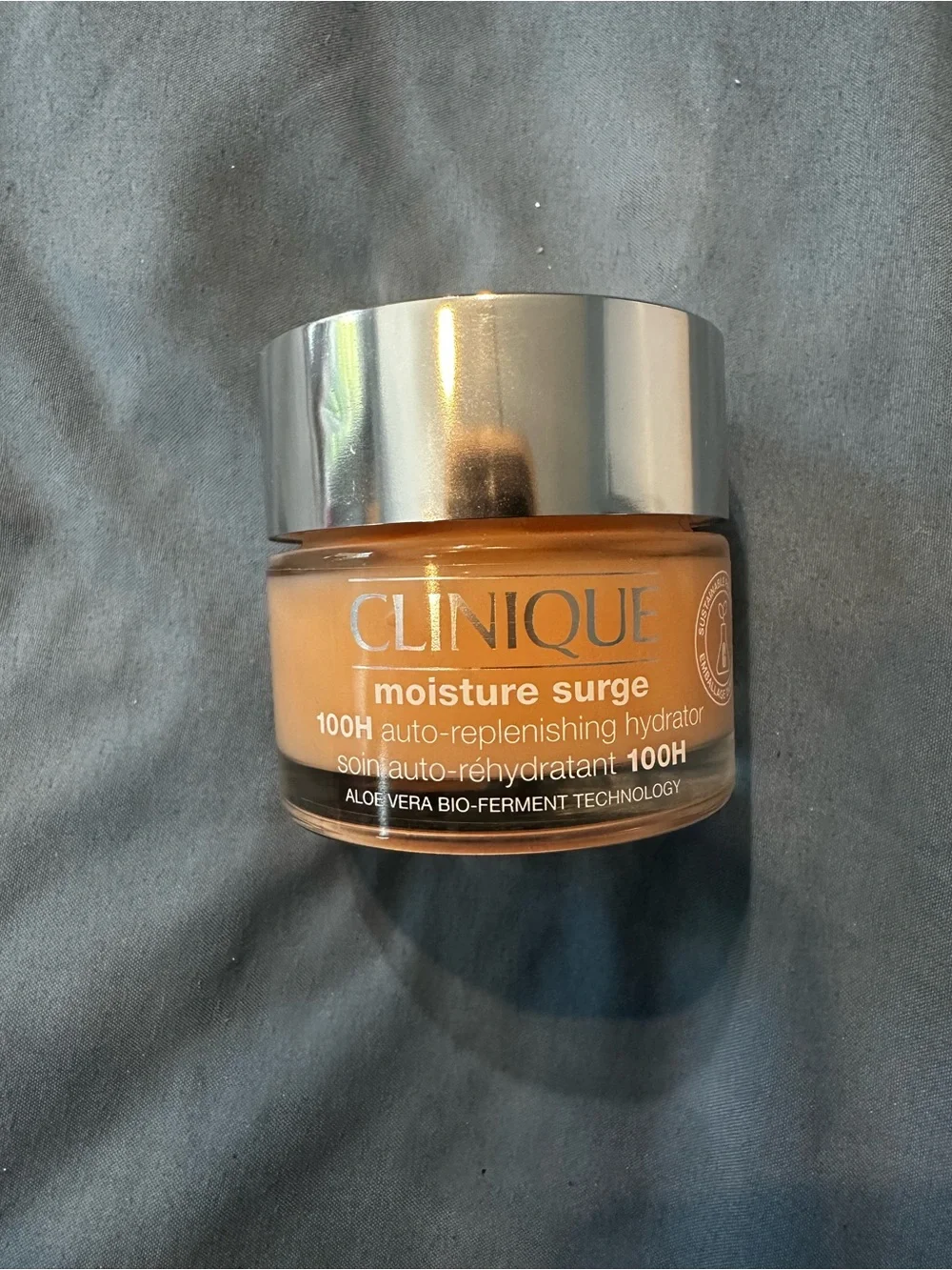 Clinique Moisture Surge Hydrator - Peach-Orange Jar with Silver Lid